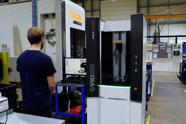 CNC optical inspection system verifying machined parts on the shop floor